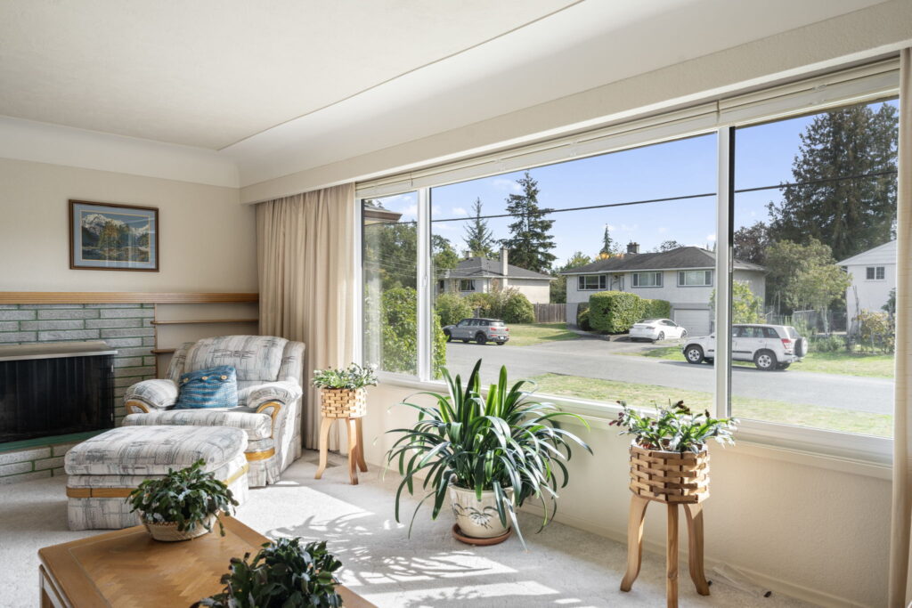 living room with large window in victoria bc home
